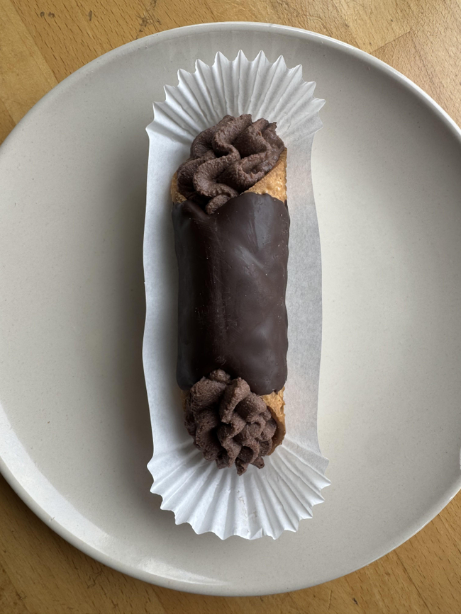 Chocolate Cannoli: chocolate covered tube shaped pastry shell filled with sweetened ricotta, cocoa and orange zest