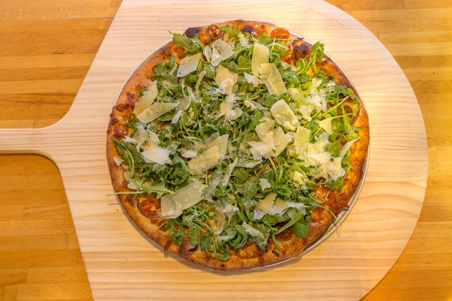 18” Arugula Pie:  white pizza, marinated cherry tomatoes, red onions, fresh arugula salad, parmigiano cheese.