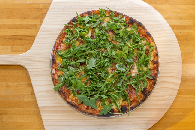 18” Q Bridge:  Italian ham, fresh pineapple, bacon, red onions, chili oil, arugula