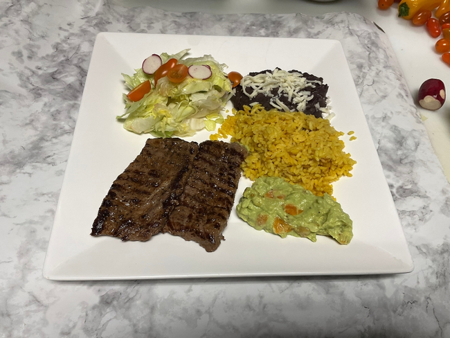 Tampiqueña with beans, guacamole, and corn tortillas