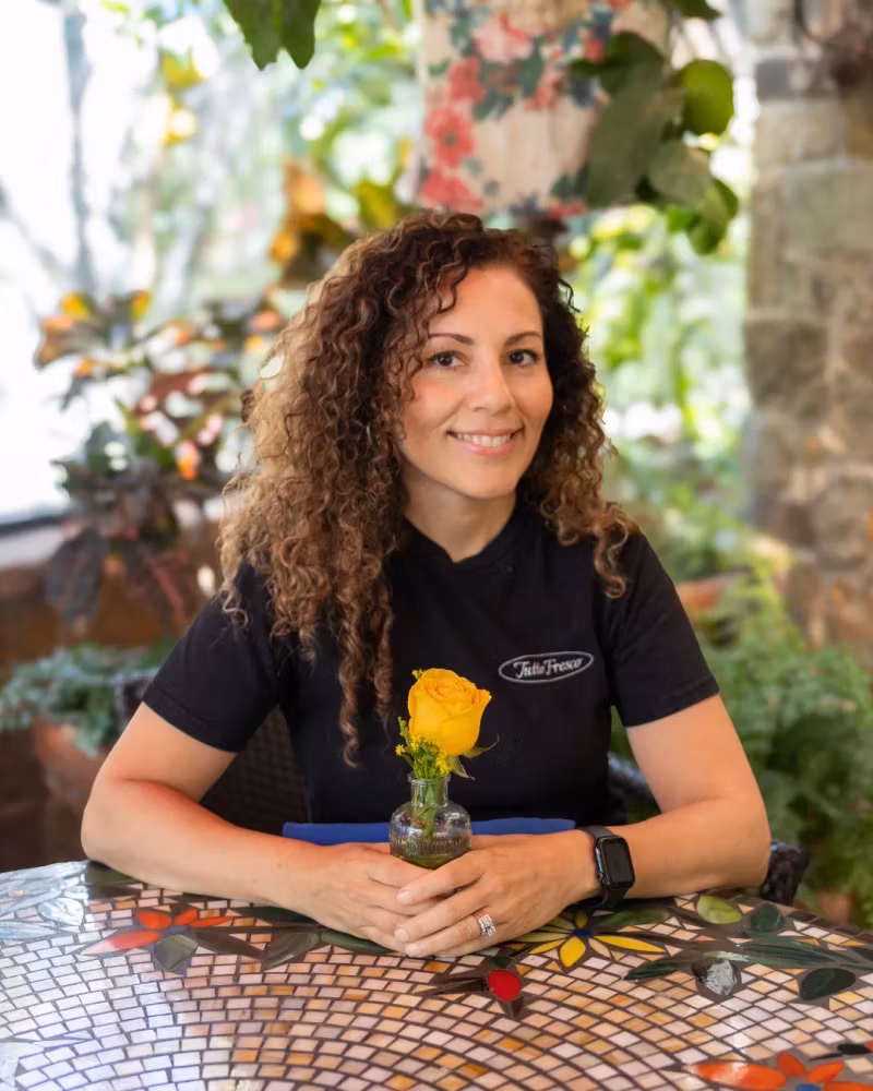 Tutto Fresco Rancho team member at a mosaic table