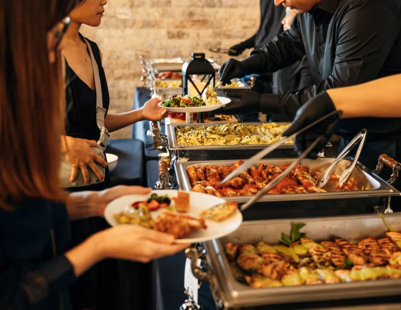 Tutto Fresco team serving guests at a catered event