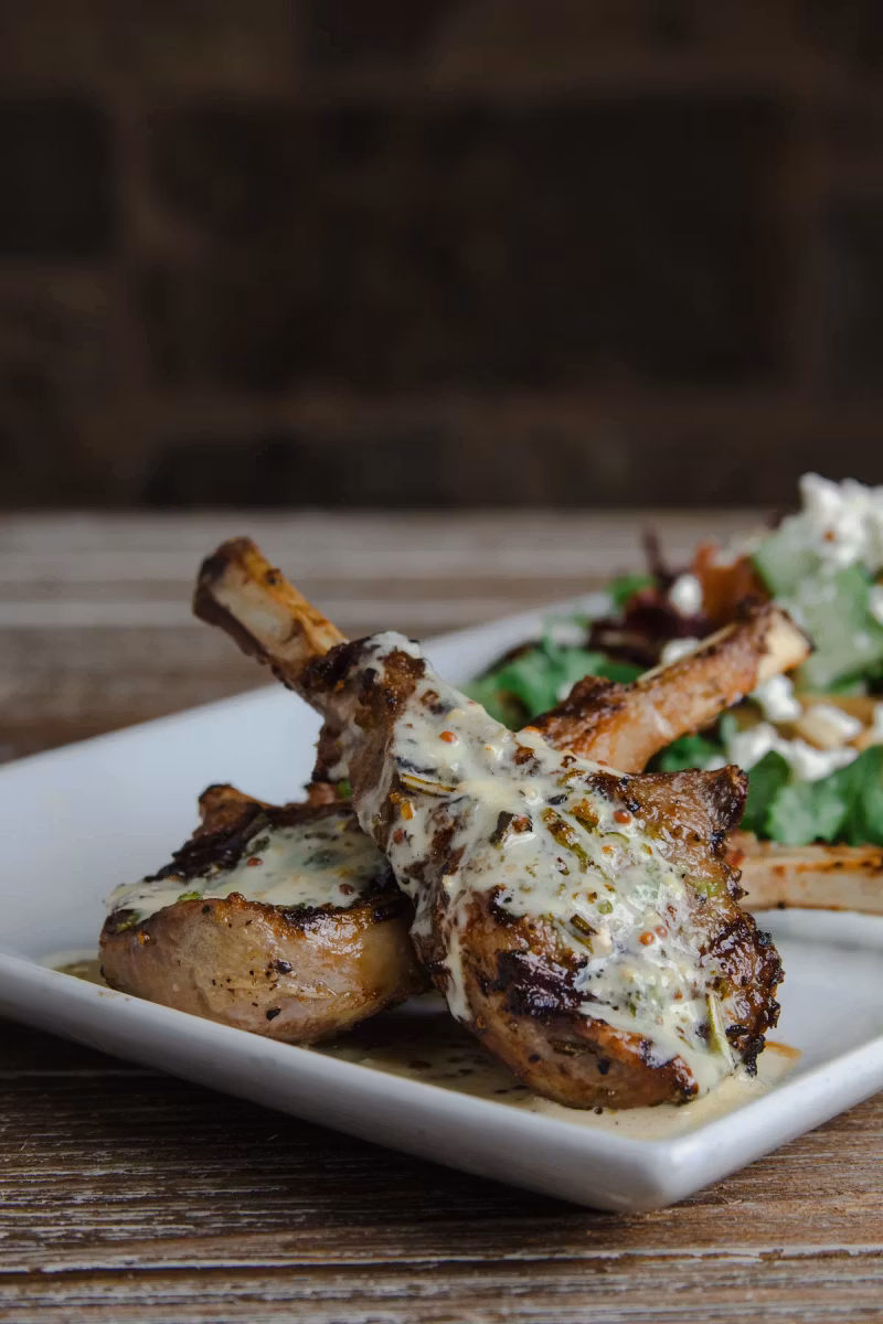 Grilled lamb chops with a cream sauce and greens