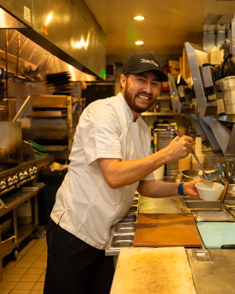 Tutto Fresco Rancho chef plating a dish in the kitchen