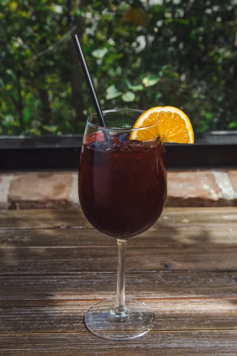 Glass of red sangria with an orange slice