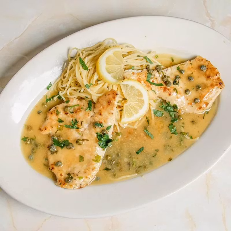 Chicken piccata with capers and lemon butter sauce over angel hair