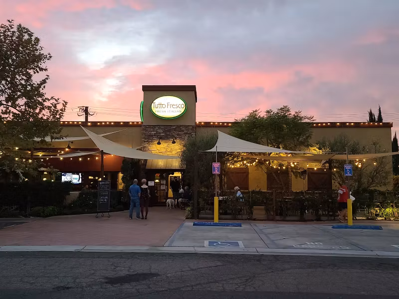 Tutto Fresco at dusk, lights on and the patio open