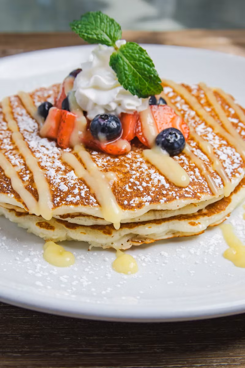 Lemon ricotta pancakes with berries and whipped cream
