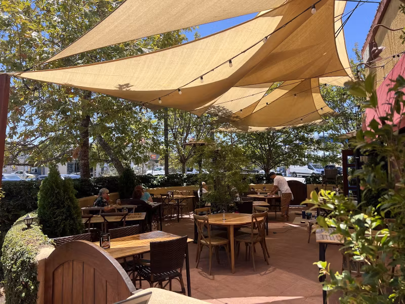 Patio tables beneath shade sails