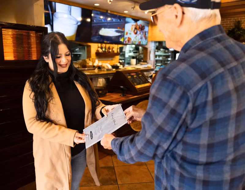 Guests greeted with a menu at the host stand